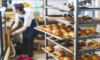 Fresh French Bread and croissants in a bakery in cooling rack