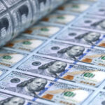 United States 100 dollar bills printing with american money printing press, uncut us dollars sheet closeup. US economy, banking, finance, tax, cash, stock market, business investment design background