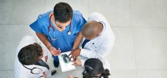 Shot of a diverse team of doctors viewing an x-ray on a digital tablet; Photo courtesy of Cecilie_Arcurs/E+/Getty Images